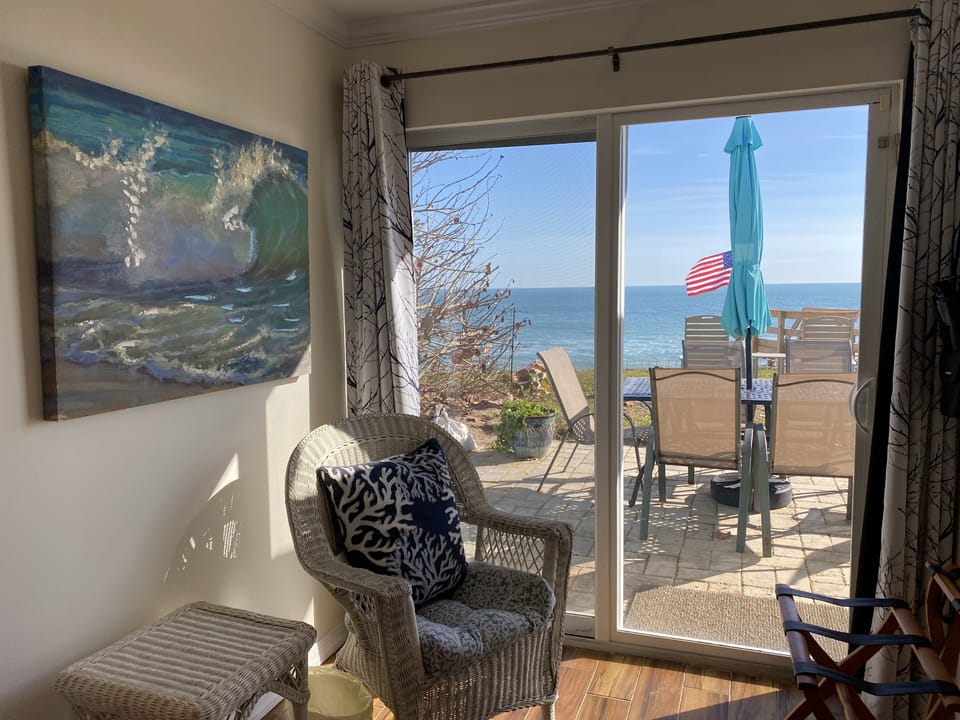 Primary bedroom sitting with doors to the patio and beach
