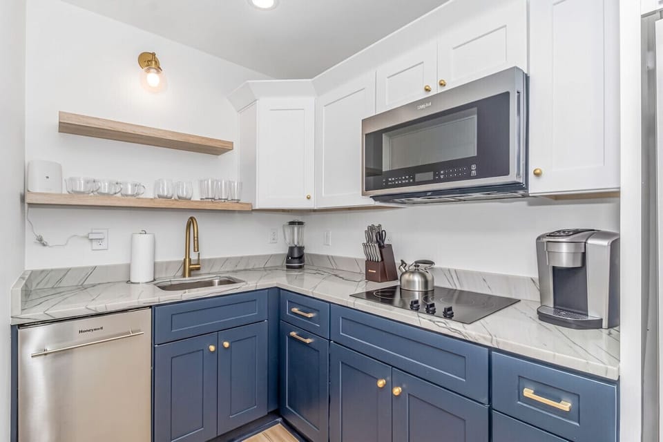 Updated kitchen featuring coffee maker, sleek counters & clean layout