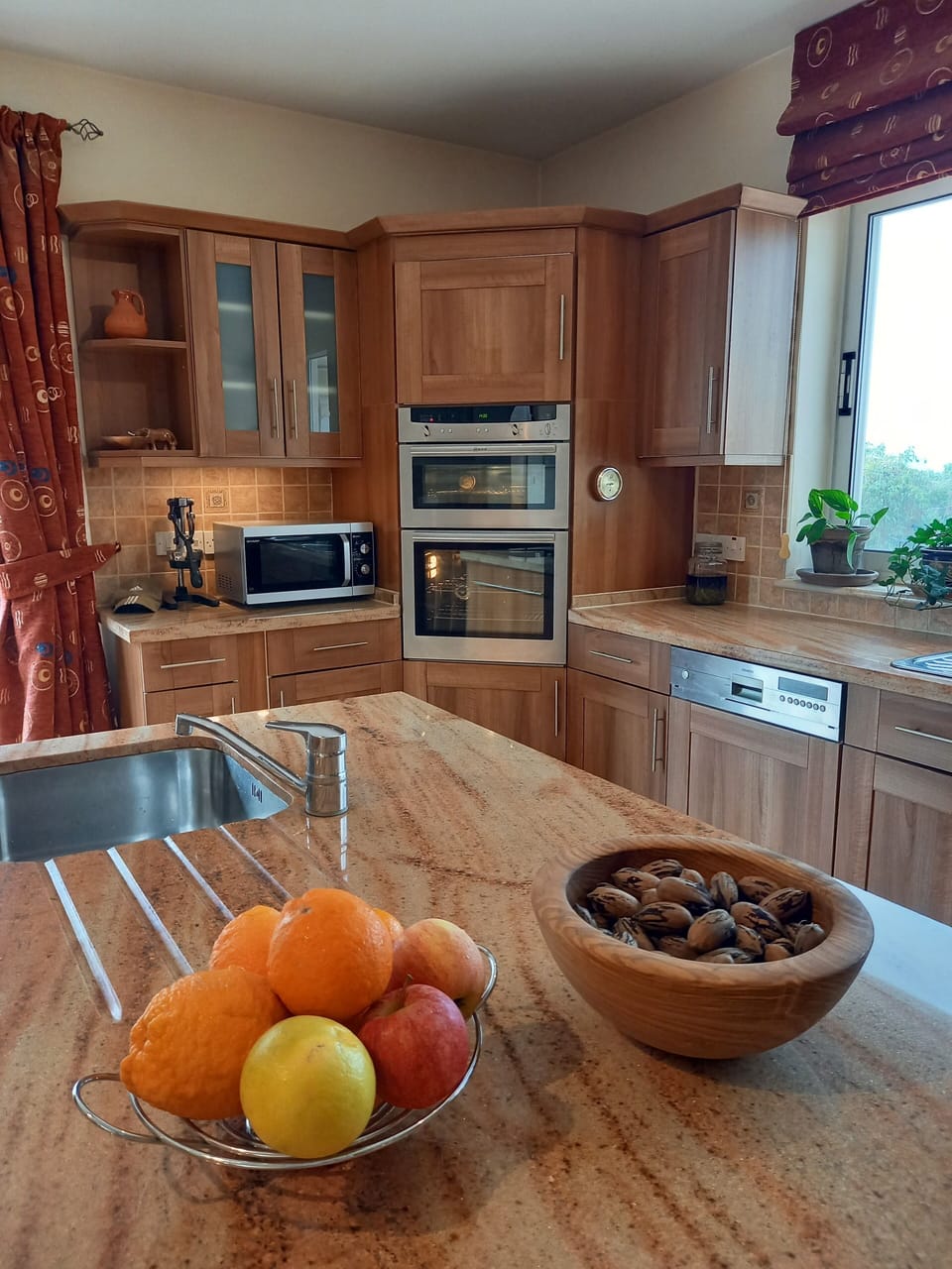 Kitchen view showing island, Neff double-oven, microwave, dishwasher