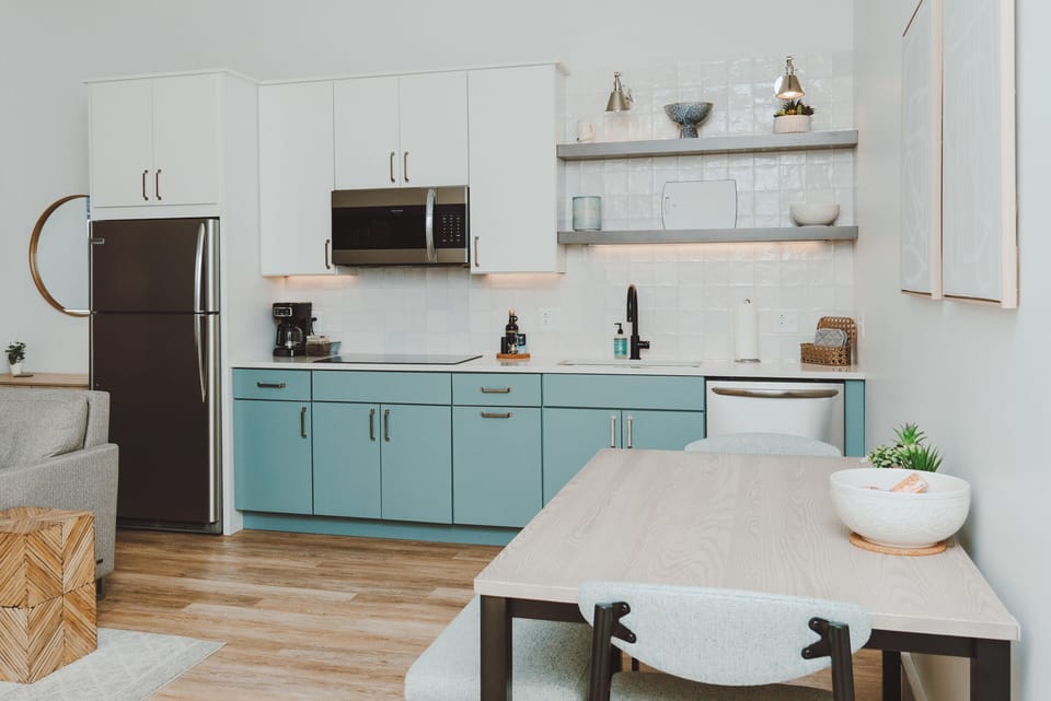 Kitchen area is fully equipped with dishes, pots/pans, microwave, and more.