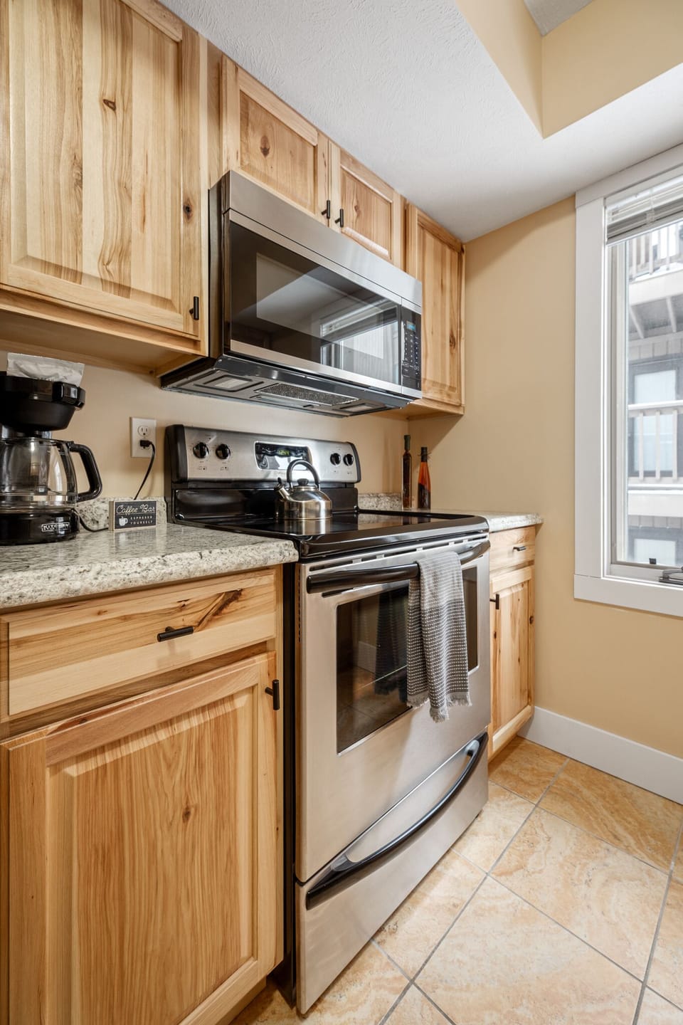 Cook with ease in the fully equipped kitchen featuring granite counters & stainless steel appliances.