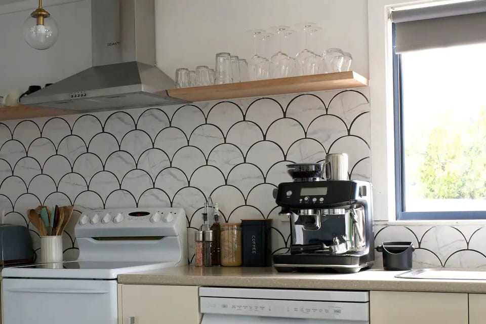 A complete kitchen setup, stocked with essential condiments and coffee machine