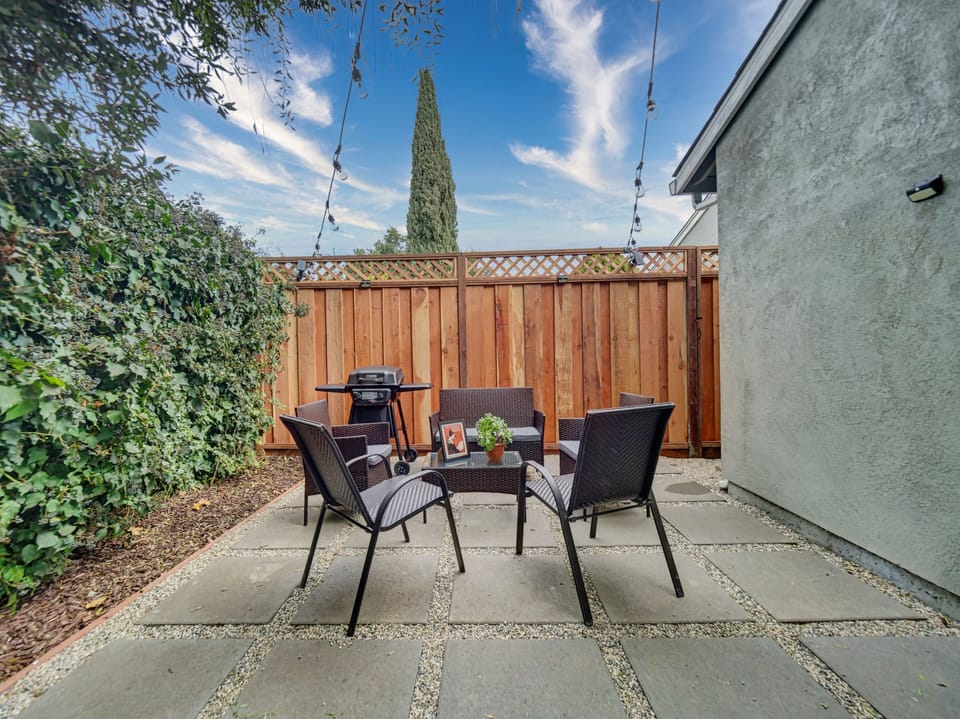 Newly renovated/ welcoming shared backyard featuring a willow tree, brand-new furniture, and a BBQ