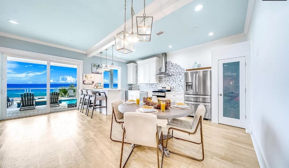 Your dream kitchen opens to endless ocean views, where morning coffee meets sea breeze through expansive windows.