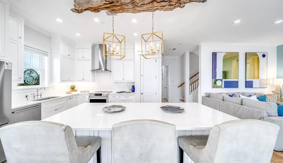 Your elegant kitchen features marble countertops, gold pendant lights, and flows seamlessly into the comfortable living space.