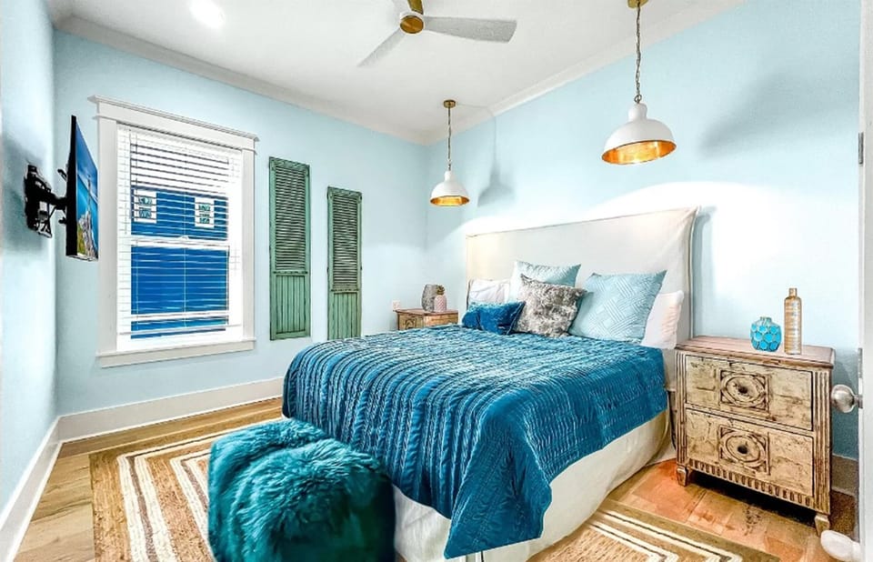 Drift off in this coastal-inspired bedroom where calming blues and elegant pendant lights create your perfect seaside sanctuary.