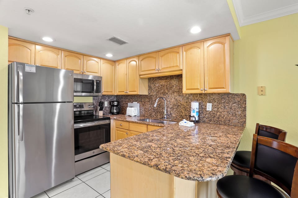 Full Kitchen with Stainless Steel Appliances.