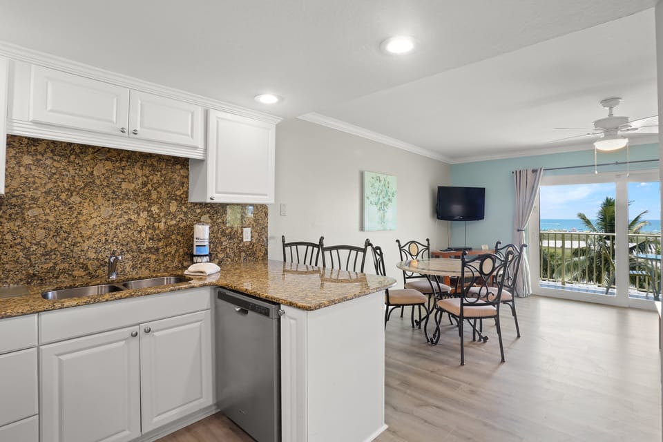 Full Kitchen With Stainless Steel Appliances.