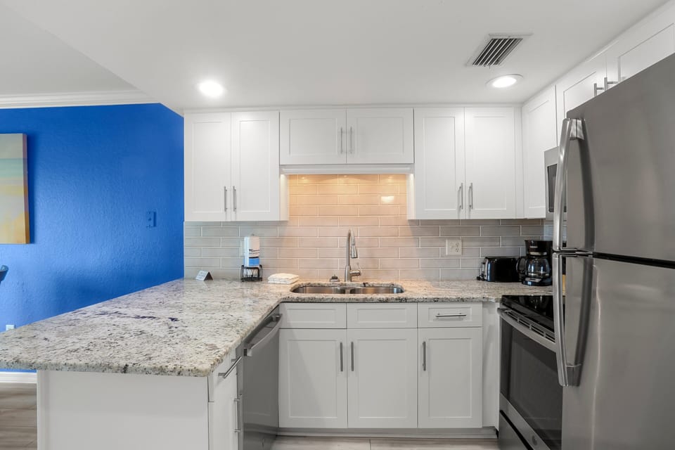 Full Kitchen with Stainless Steel Appliances.