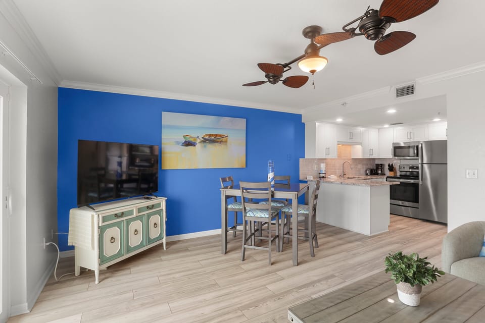Open Living/Dining Room with Sleeper Sofa and Balcony Access.