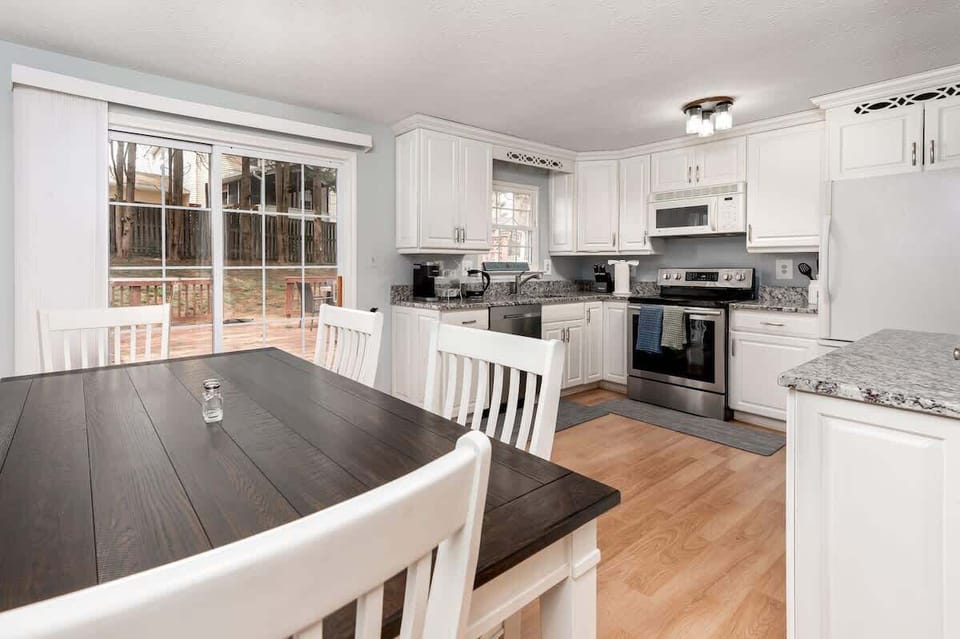 Bright open dining area connected to a fully equipped kitchen