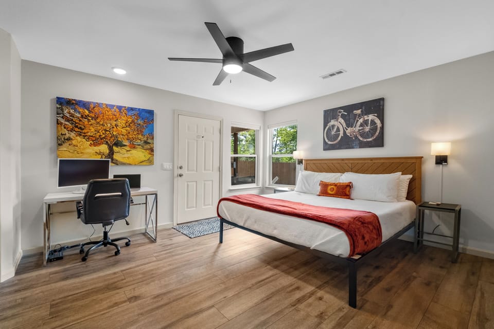 Primary bedroom with a king size bed, Smart TV for streaming, & access to deck!