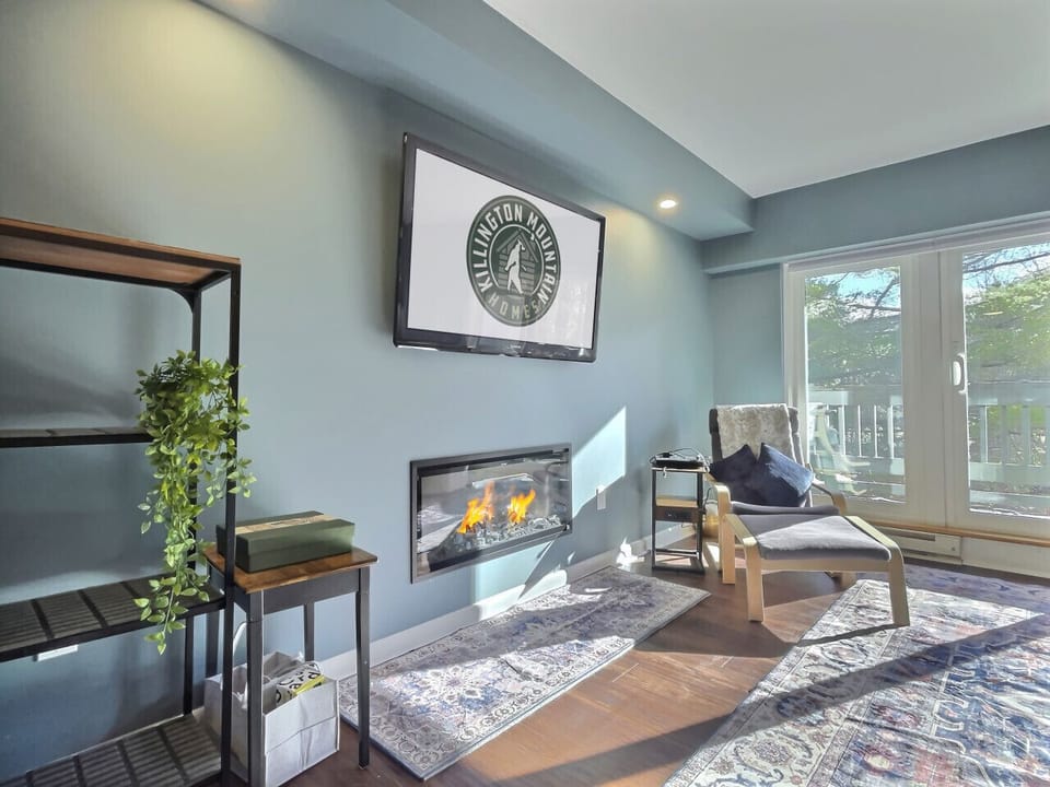 Relax in the living room with a warm fireplace and Roku TV.