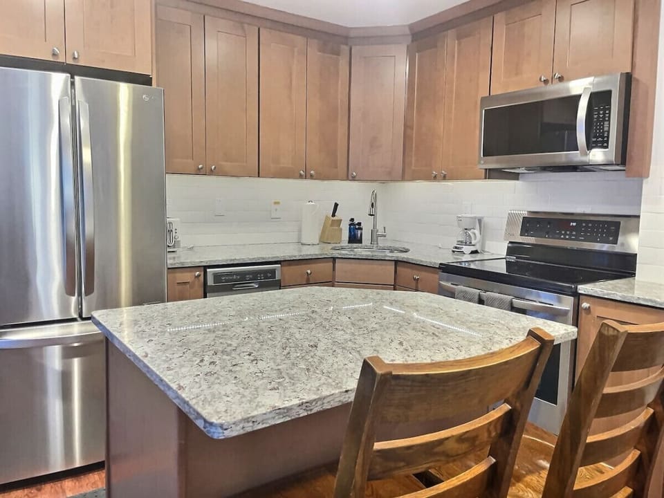 Simplicity meets sophistication: Our minimalist kitchen boasts stylish quartz countertops, elevating your culinary space with a touch of modern elegance.