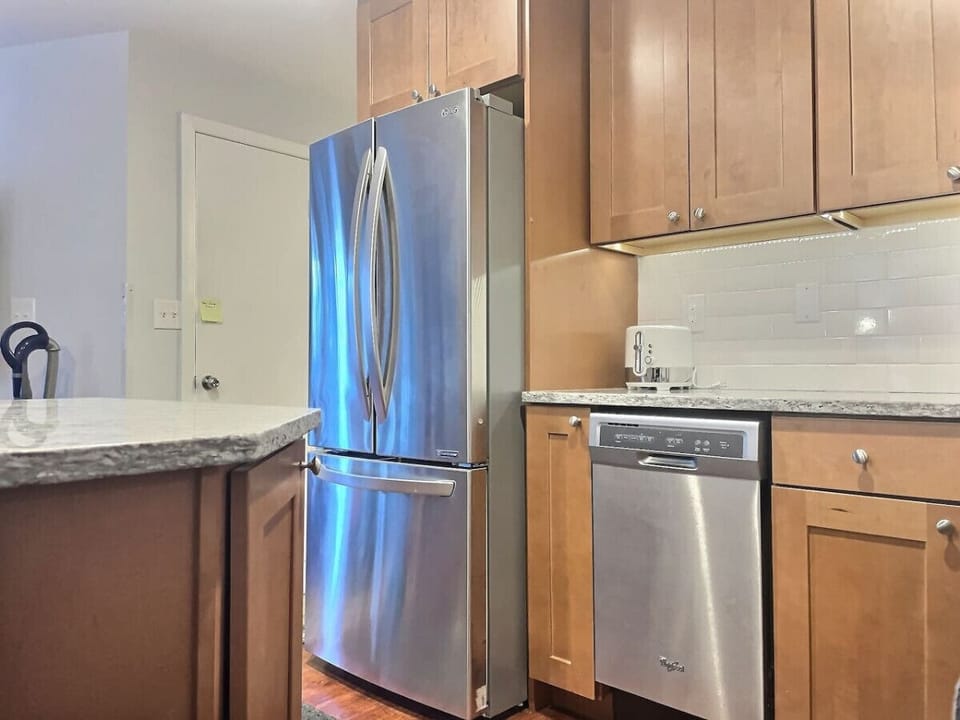 Simplicity at its finest: A minimalist kitchen adorned with timeless wooden cabinets, where less truly becomes more.