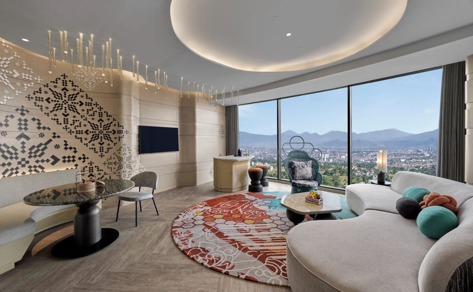 Suite, 1 Bedroom (Sky View) | Living room | 50-inch Smart TV with cable channels, books