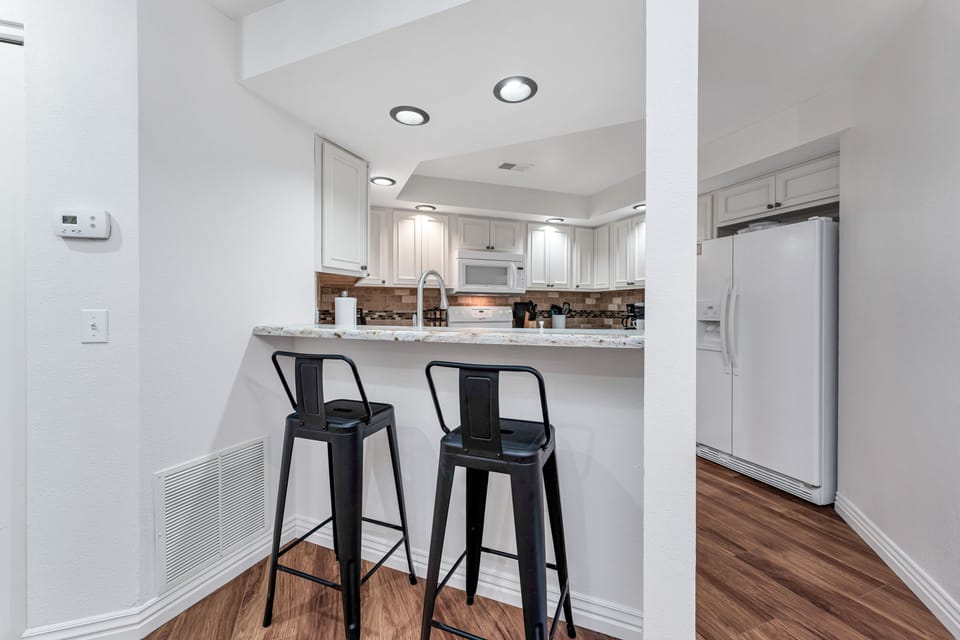 2 bar stools allow casual entertaining and conversation while prepping meals.