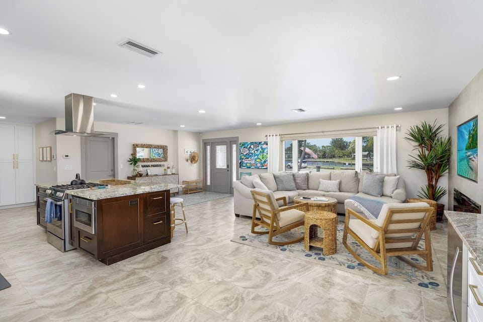 Main house large living area with scenic view of basin and bay in front and pool area in back 