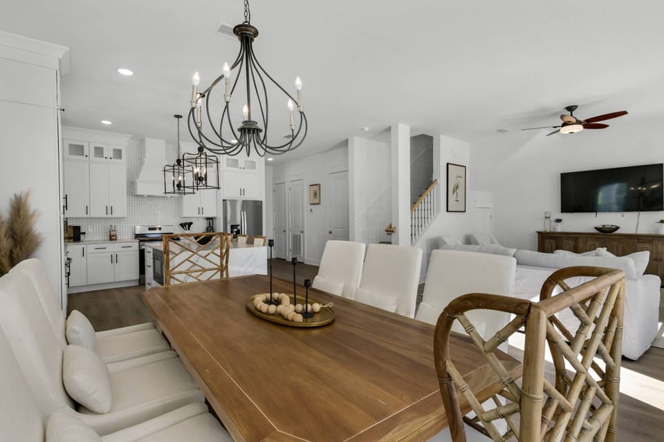 The dining area features a large farmhouse style table with comfortable seating for 8, and additional seating for 3 at the expansive kitchen island!