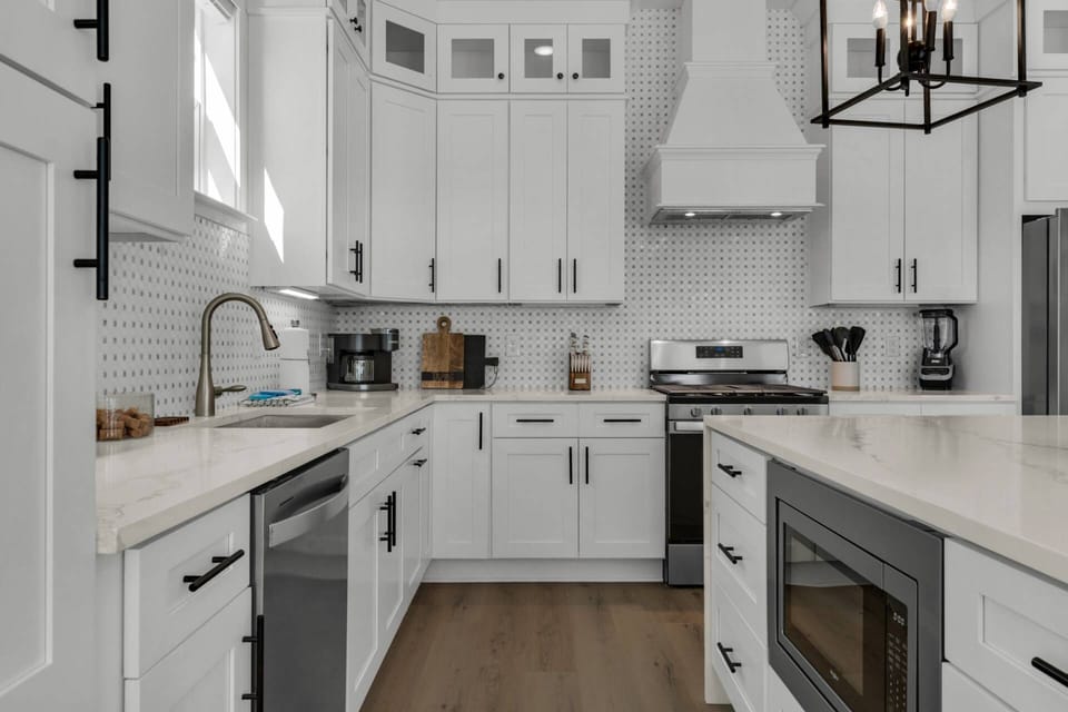Well appointed kitchen is fully stocked with everything you will need,  beautifully furnished with stainless steel appliances, and quartz countertops.