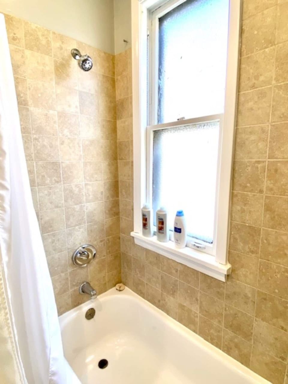 Clean full bathroom with shower/tub, vanity, and stocked basics for your stay.