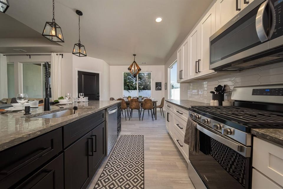 Heart of the home: A beautifully crafted kitchen with state-of-the-art appliances and inviting dining area, ready for culinary creations and shared moments