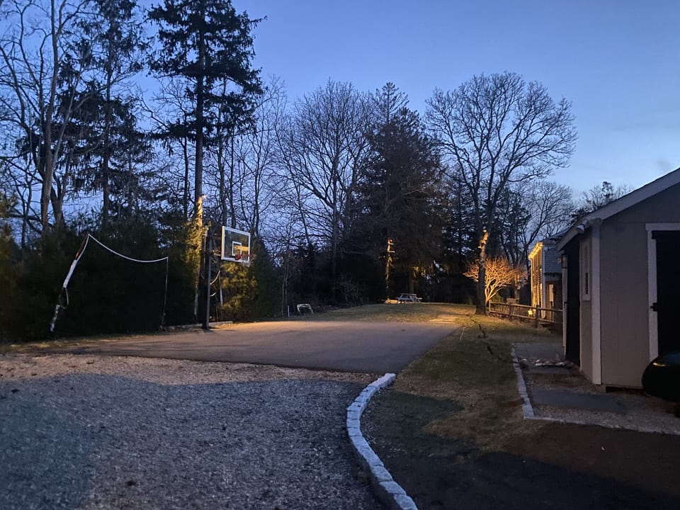 Large private backyard with sport court and adjustable basketball hoop! 