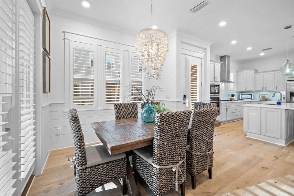A dining space featuring a natural wood table, soft lighting, and elegant decor.