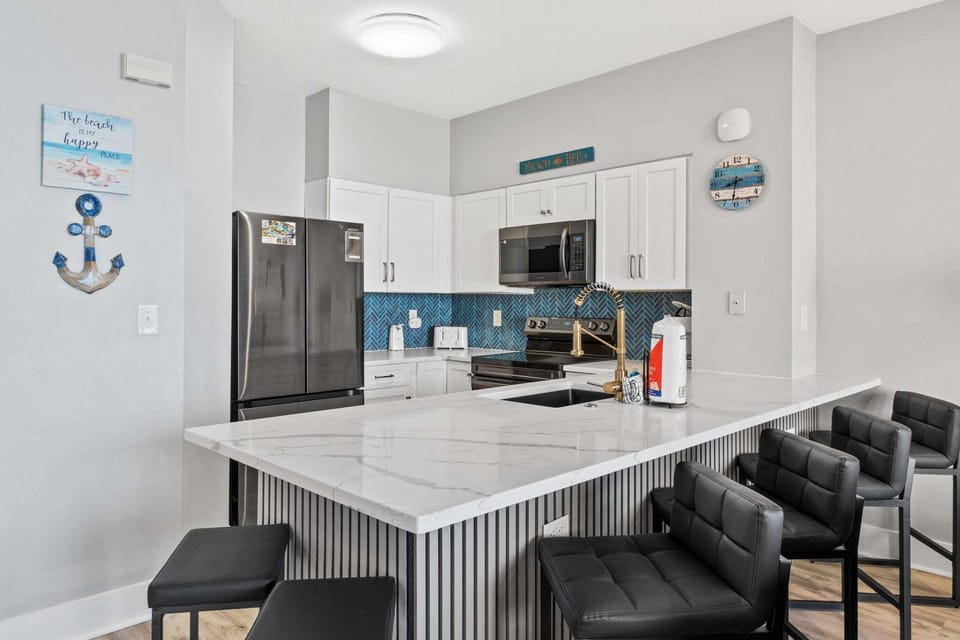 The newly remodeled kitchen features sleek modern appliances that make meal prep easy and efficient.