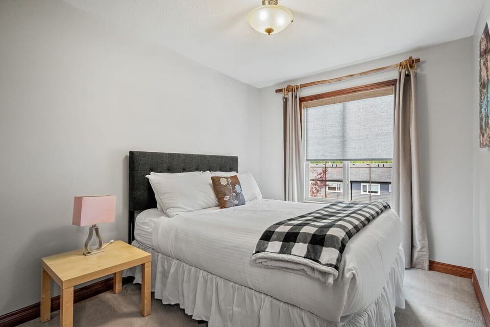 Second bedroom, located upstairs, with a queen bed.