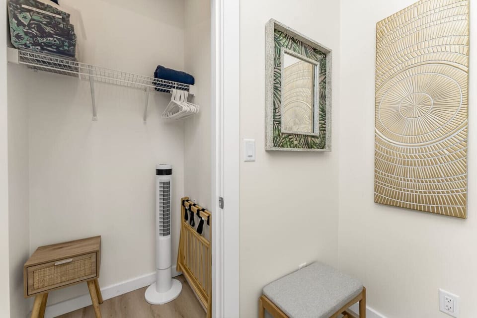 Walk in closet with hangers, extra blankets and pillows, luggage rack, and additional storage space for a comfortable stay.