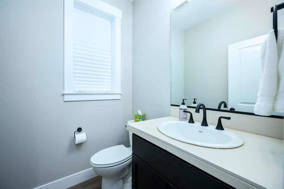 Private ensuite bathroom featuring modern fixtures and ample counter space.
