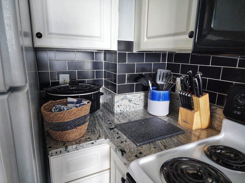 Kitchen: Modern elegance awaits with stylish granite, chic decor, and all you need to whip up meals!
