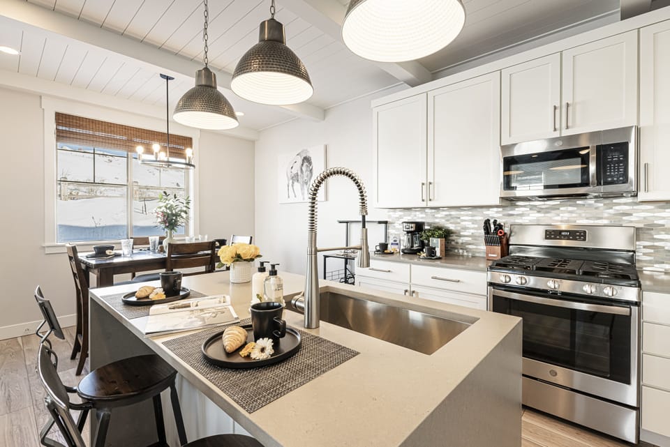 Fully Equipped Kitchen with Stainless Steel Appliances, Gas Range, and Bar Seating for 2