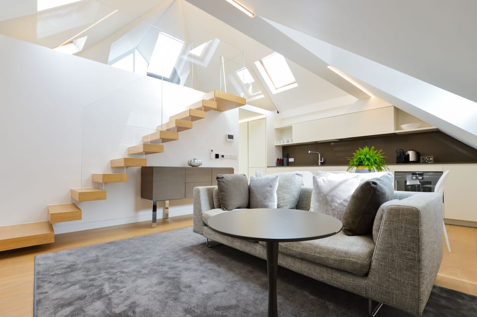 1 Bedroom Deluxe Penthouse | Living area | 32-inch flat-screen TV with cable channels, heated floors