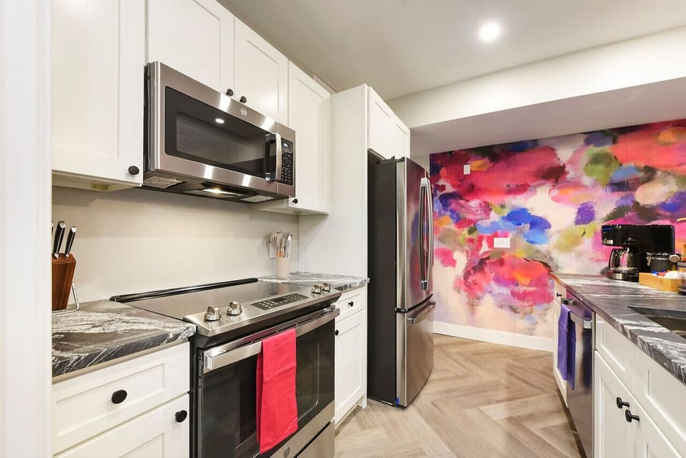 Fully equipped kitchen with sleek appliances and a beautiful design.
