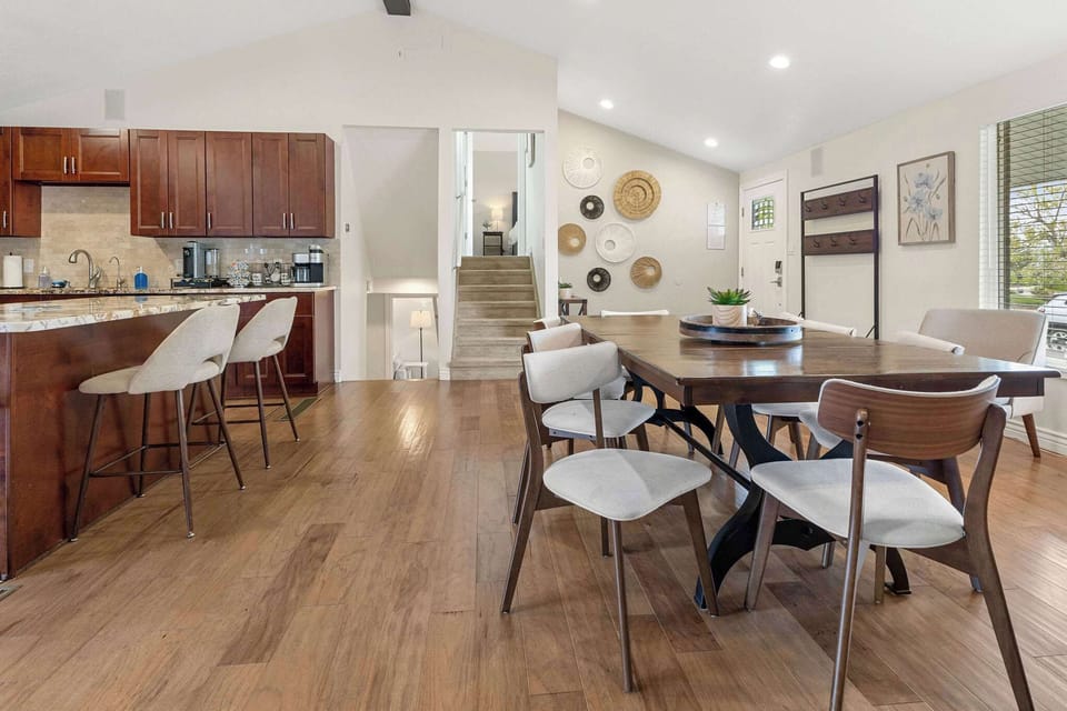 The kitchen is open to the front door and dining table.