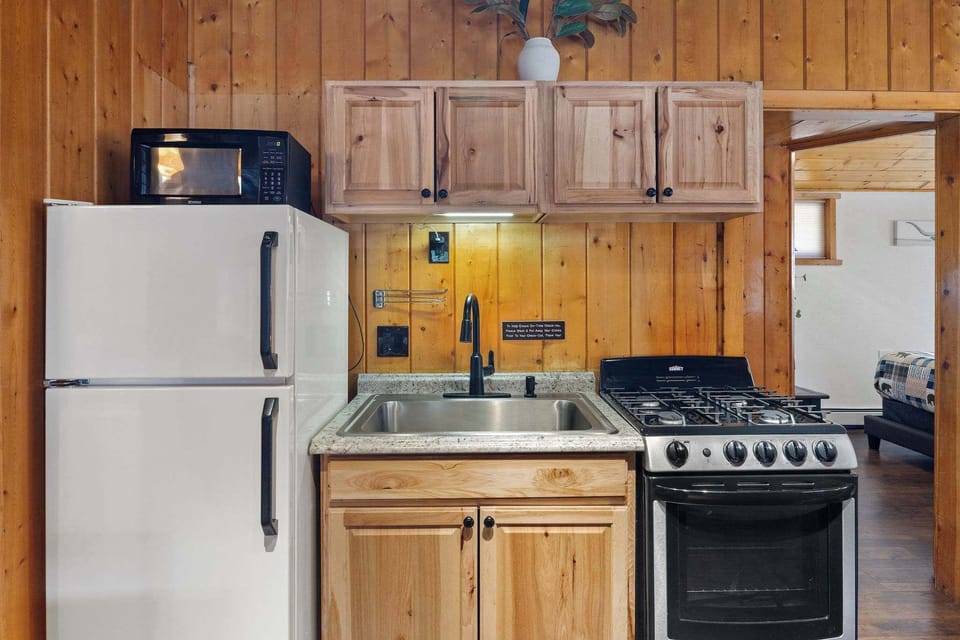 The kitchen has a gas stove, microwave, refrigerator and coffee maker.