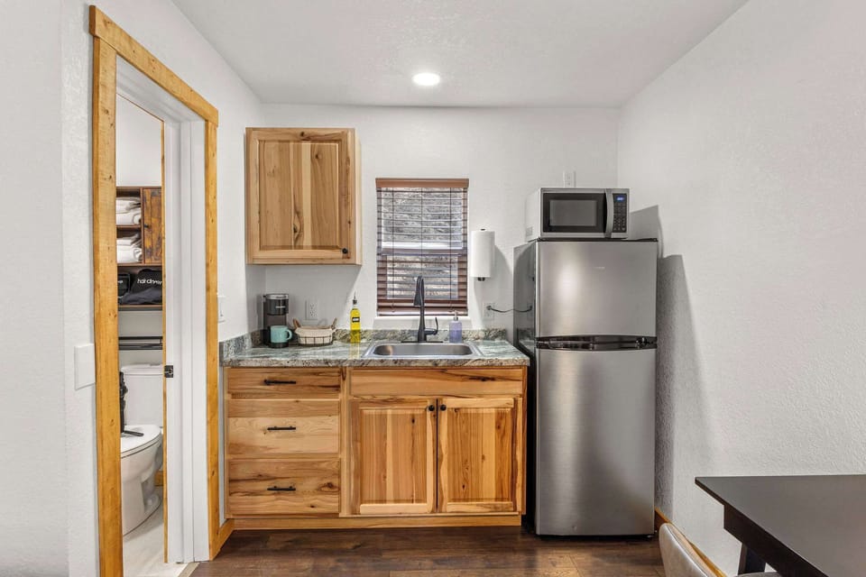 The kitchen has a refrigerator, microwave, coffee maker and hot plate.