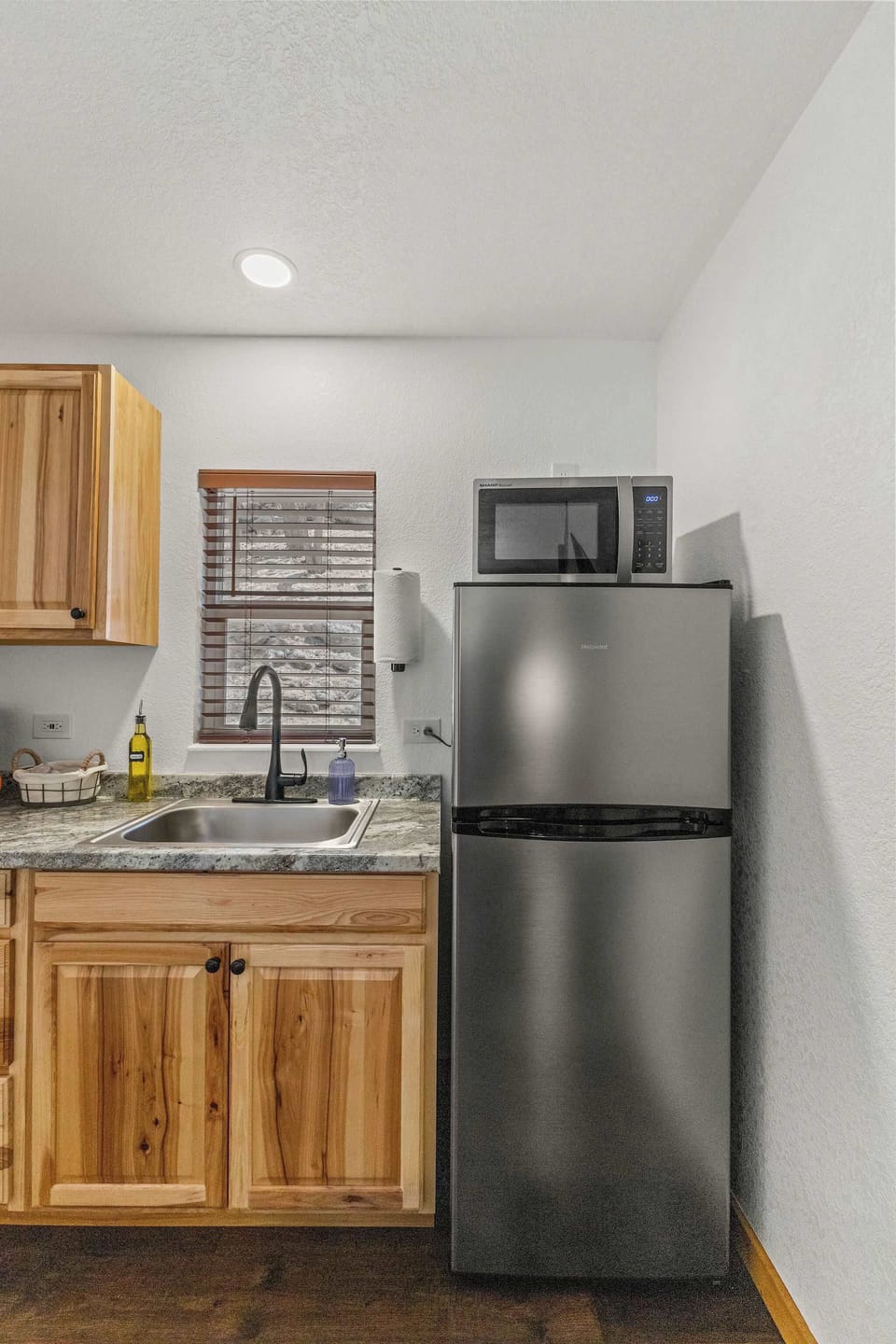 The kitchen features a coffee maker, refrigerator, microwave and hot plate.