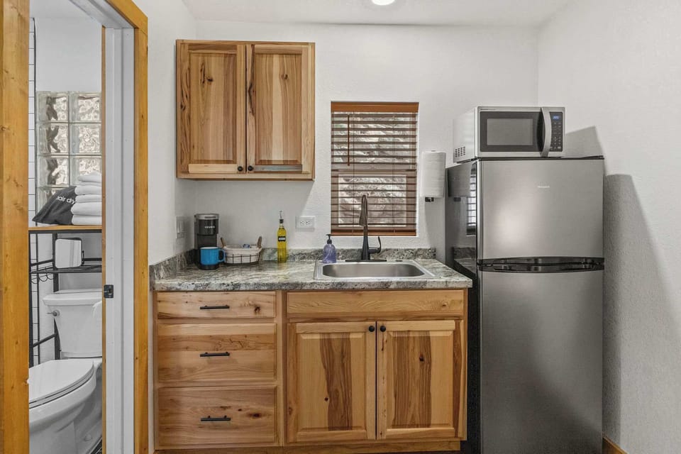 The kitchen has a refrigerator, microwave, coffee maker and hot plate.
