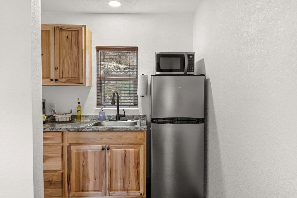 The kitchen features a coffee maker, refrigerator, microwave and hot plate. This is the only sink in the unit.