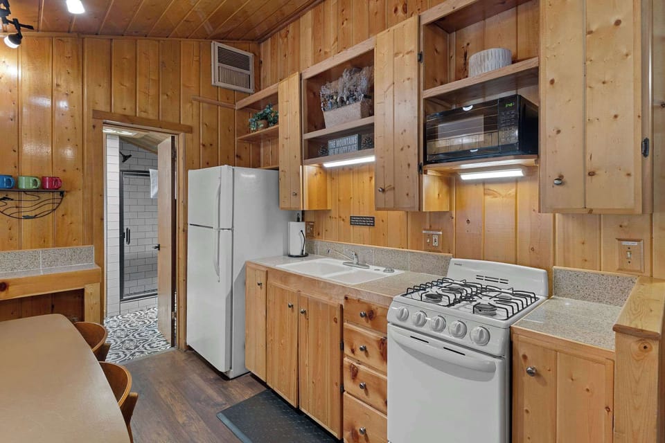 The kitchen has plenty of dishes, cups, utensils and cookware so you can make a delicious meal.