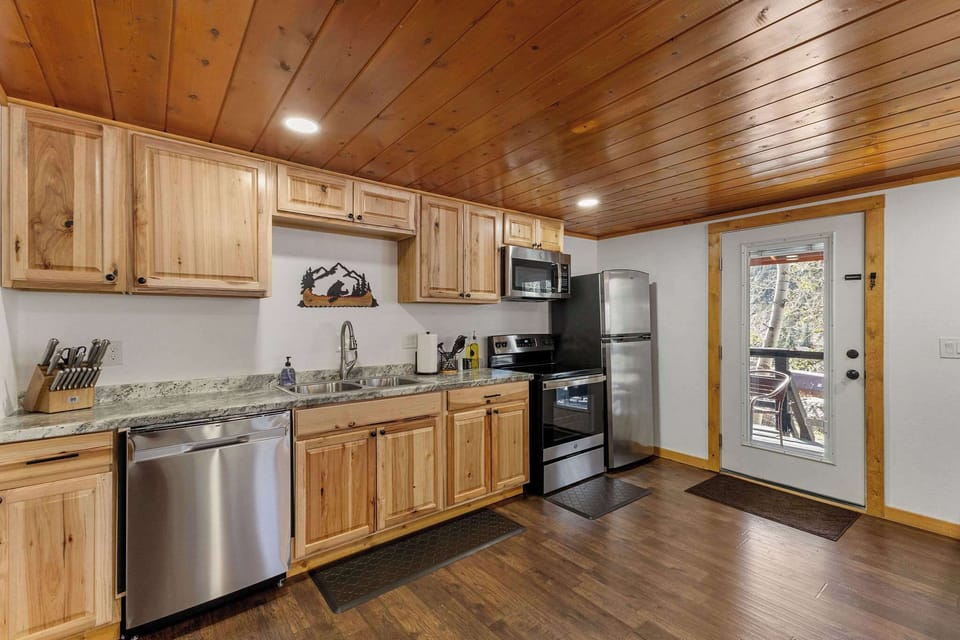The kitchen has new, stainless steel appliances and plenty of cookware and utensils.