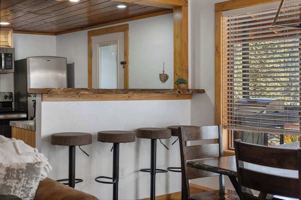 Grab a stool and sit at the live-edge wooden countertop