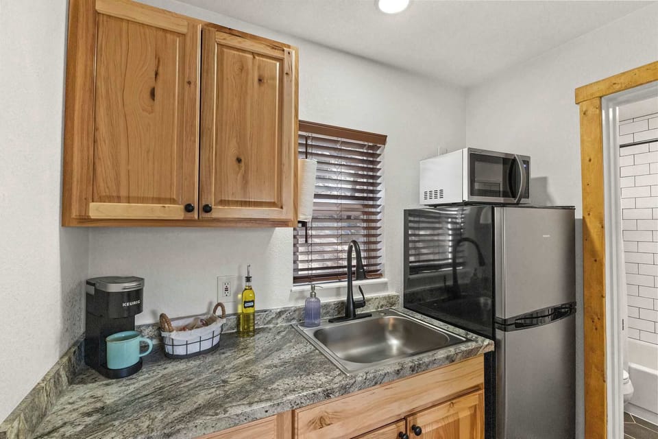 The kitchen has a refrigerator, microwave, coffee maker and hot plate.