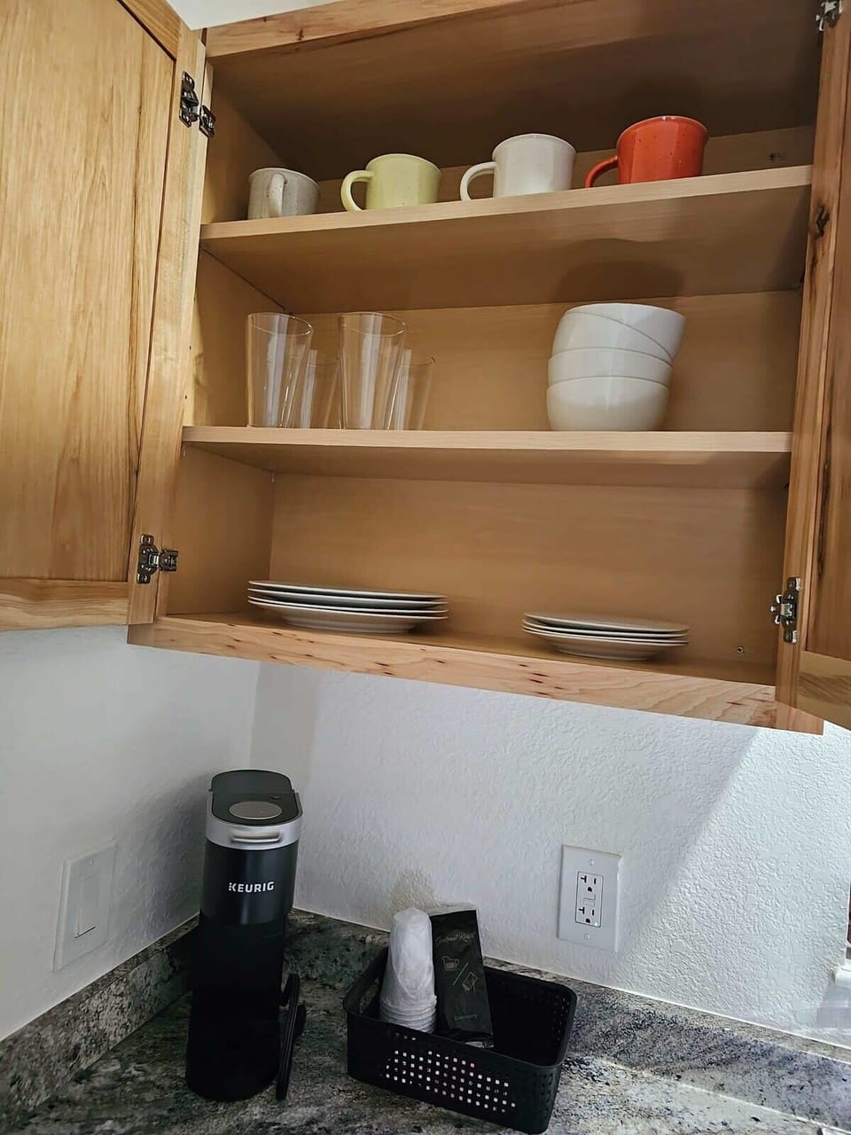 Fully stocked with dishes, silverware and coffee mugs!