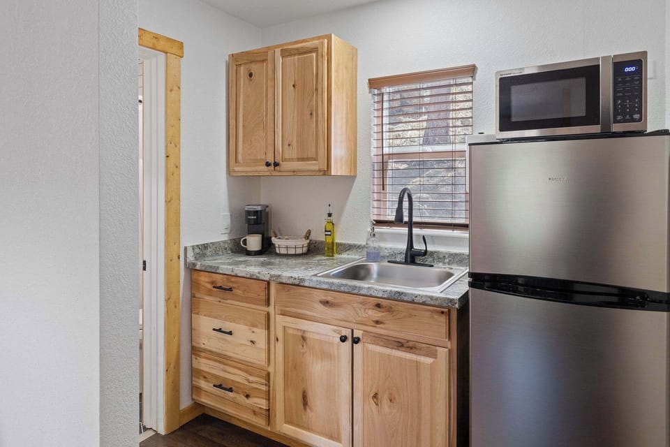 The kitchen has a coffee maker, refrigerator, microwave and a hot plate.