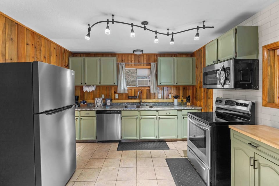 The full kitchen has a dishwasher, refrigerator, stove, microwave and coffee maker.
