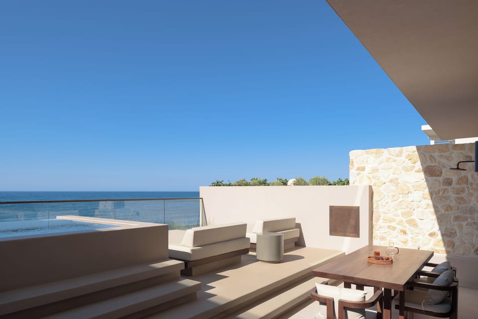 Premium day beds with bespoke dining settings overlooking the Aegean Sea.